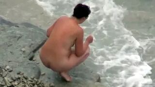 she is peeing in the water near the beach